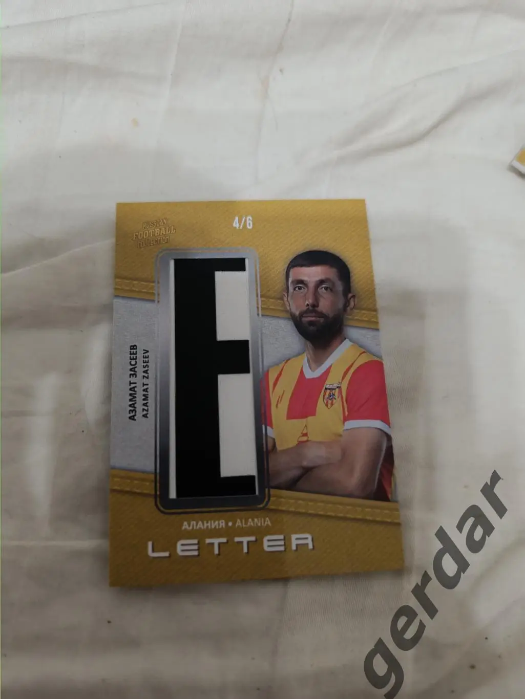 Азамат засеев Алания Владикавказ. карта с куском игровой джерси буква