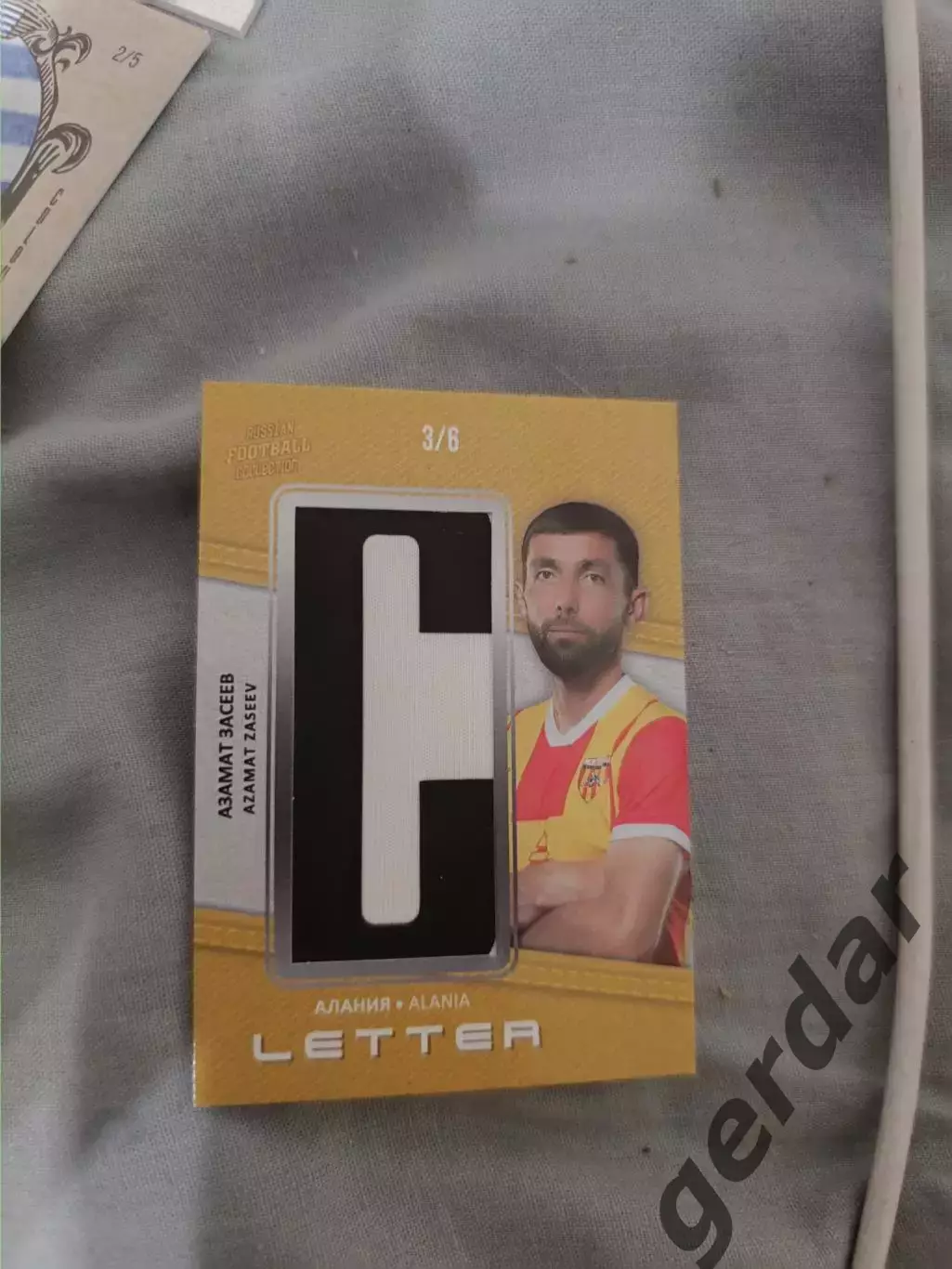 Азамат засеев Алания Владикавказ. карта с куском игровой джерси буква 2